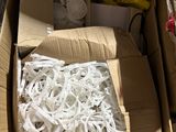 a box of shredded paper sitting on the ground