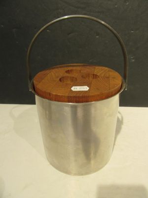 a metal bucket with a wooden lid on a table