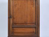 an old wooden cabinet with a door on top of it