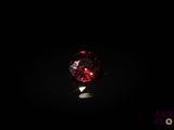 gros plan d'un diamant rouge sur une surface noire