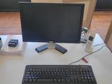 a keyboard, mouse, and monitor on a desk