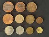 a lot of different coins that are on a table