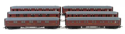 four red and blue train cars sitting next to each other on a white surface