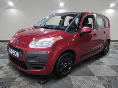the red citrole is parked on a checkered floor