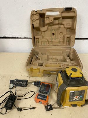 a box with a laser level and other tools on a table