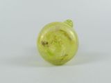 yellow glass christmas ornament on a white background