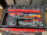 many tools in a tool box on the floor
