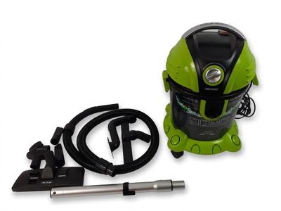 the vacuum is green and black with a hose and power cord