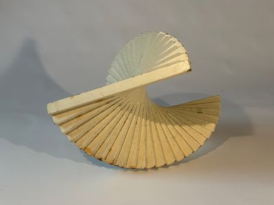 a paper fan that is sitting on a table
