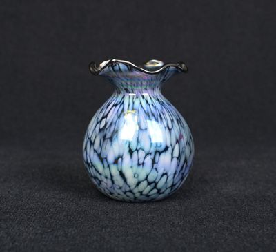 a blue and white vase sitting on top of a black table
