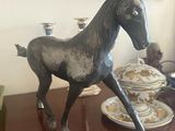 a statue of a horse that is standing on a table
