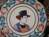 a person holding a plate with a picture of a man on it
