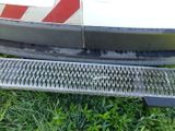 a close up of a metal grate on the side of a bus