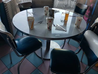 a table with four chairs and a cup of coffee on it
