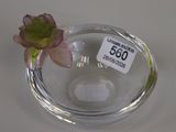 a glass vase with a flower in it on a table