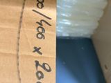 a cardboard box with a label on it sitting on top of a box