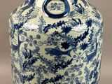 a blue and white vase with a dragon design on it
