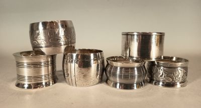 many silver cups sitting on a table next to each other