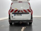 a white van with red and white stripes parked in a parking lot