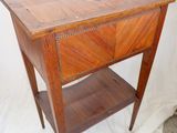 a small wooden table with a drawer on top of it