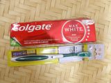 two toothbrushes and a tube of toothpaste on a table