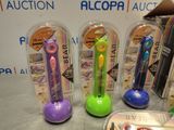 several different colored toothbrushes in plastic containers on a table