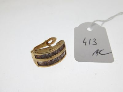 a ring and a tag on a white table