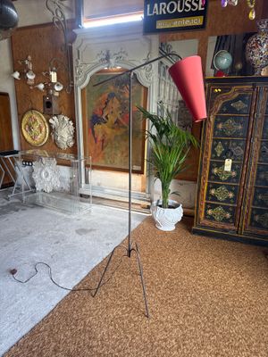 a lamp that is on a tripod in a room