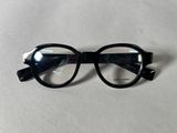 black glasses with clear lenses on a white surface