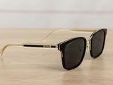 a close up of a pair of sunglasses on a wooden table