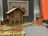 a small model of a building with a fence around it