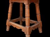 an old wooden stool with a wooden seat on a black background