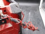 a close up of a red tool on a black surface
