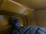 a close up view of a tire on a yellow truck