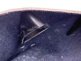 a close up of a bag with a small triangle on it