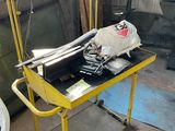 a yellow cart with a bag on it in a garage