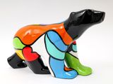brightly colored dog figurine on a white surface with a white background