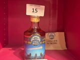 une bouteille d'alcool dans une boîte rose sur laquelle est apposée une étiquette de prix