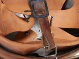 a brown leather helmet with a leather strap on it