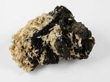 a close up of a piece of black and white rock on a white surface