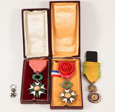 three medals and a medal in a case on a white surface