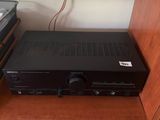 a black receiver sitting on top of a wooden cabinet
