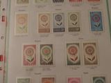 a lot of stamps on a table with a pair of scissors