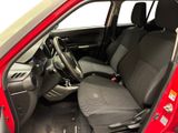 the interior of a small red car with black seats and a steering wheel