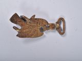 an old brass key with a bird on it