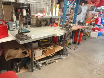a picture of a workbench in a garage with a lot of tools on it