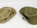 two hats are sitting next to each other on a white surface