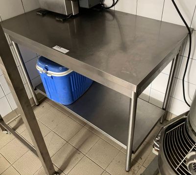 a stainless steel table with a blue bucket on it