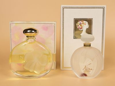 an image of a bottle of perfume next to a box of perfume
