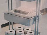 a cart with several rolls of toilet paper on top of it